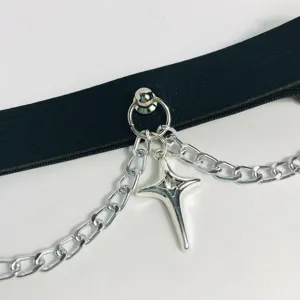 Close-up detail of Y2K punk star chain leather leg garter ring, cool gothic accessory.