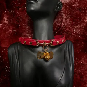 Red leather choker collar with golden bell and bone tag, stylish neck jewelry for women.