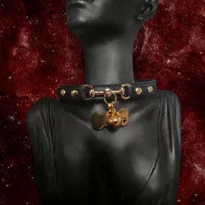 Black leather puppy choker collar with gold metal bone tag and bell for alternative fashion style.