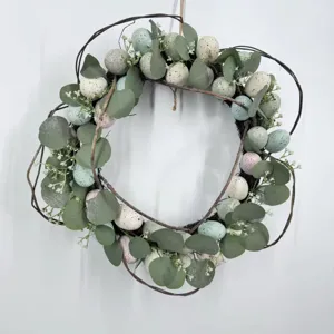 Close-up of Easter wreath with eucalyptus leaves and colorful speckled eggs