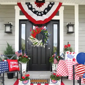 Close-up of red, white, and blue Independence Day wreath on a black front door
