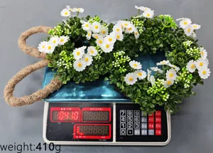 Detailed view of artificial daisy rabbit floral wreath showing product weight 410g