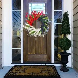 Patriotic Independence Day wreath with red white and blue flowers on front door