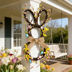 Close-up of Easter bunny wreath with colorful eggs and burlap bow on white pillar