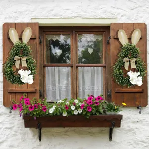 Bunny-shaped Easter wreath with burlap bow and hydrangea on wooden window shutters.