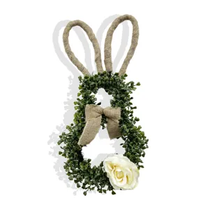 Detailed view of handmade Easter bunny wreath with eucalyptus leaves and burlap bow decoration