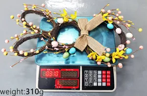 Detailed shot of an Easter bunny twig wreath with colorful eggs, weighing 310g.