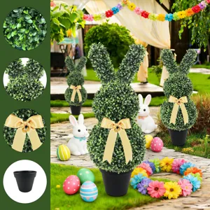Macro view of artificial rabbit topiary featuring boxwood leaves, gold bow and black pot