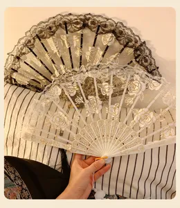 Detailed shot of New Chinese style lace folding fan with gold rose embroidery for dancing props.