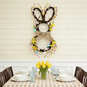 Easter bunny wreath with colorful eggs and flowers hanging in a dining room