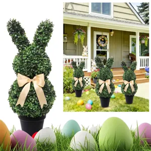 Artificial boxwood topiary bunny in a black pot with cream bow for Easter garden decor.