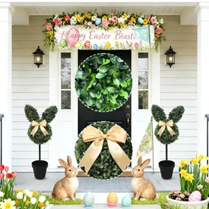 Detailed view of artificial boxwood bunny topiary with leaf texture and gold bow