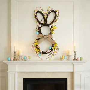 Easter bunny wreath with colorful eggs and yellow flowers displayed on a white mantel.
