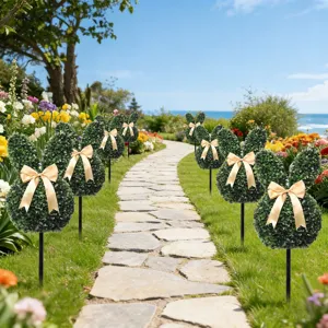 Set of artificial boxwood bunny topiaries with gold bows lining a scenic garden path