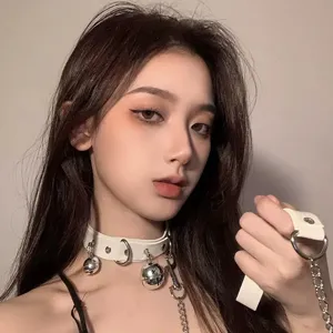 White leather choker necklace with metal bells and chain hand cuff for edgy fashion style.