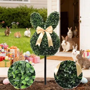 Detail view of Easter bunny artificial boxwood topiary with gold bow for garden decor.