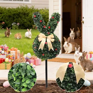 Macro view of artificial boxwood leaves and gold ribbon on bunny garden stake.
