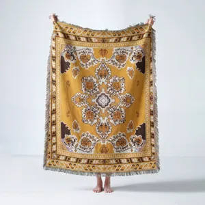 Detailed view of bohemian woven throw blanket with mandala pattern and decorative fringes