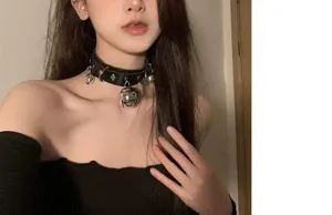 Gros plan détail du collier choker en cuir noir style punk gothique avec cloches et anneaux.