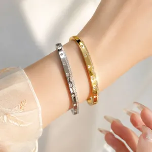 Exquisite micro-pave dot bangle detail, elegant minimalist metallic wrist jewelry for daily wear.