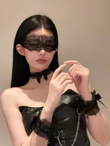 Detailed shot of black lace choker necklace, lace blindfold and cute wrist cuffs set.