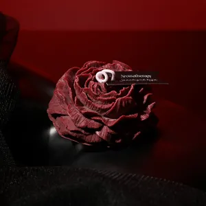 Dark red peony shaped scented candle, romantic low temperature wax for intimate massage.
