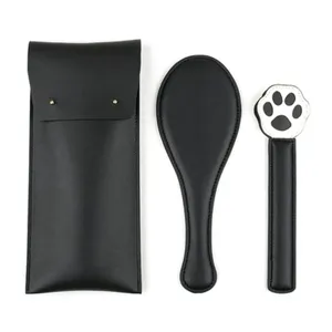 Detailed view of black PU leather adult SP novelty prop set including storage bag and paddle.
