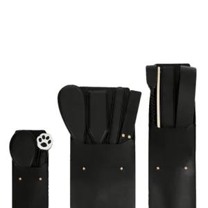 Black leather storage bag set with practice paddles and whips, sleek design for organization.