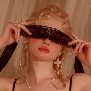 Detailed view of the sexy black lace eye mask, showing delicate hollow embroidery and texture.