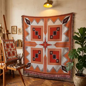 Large woven Bohemian geometric blanket displayed as a wall tapestry in a studio setting