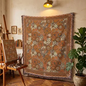 Bohemian orange floral woven blanket hung as a decorative wall tapestry in an artist studio