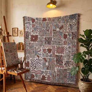 Detailed view of bohemian woven throw blanket with abstract floral pattern in art studio.