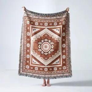 Bohemian Indian style woven camping blanket with geometric ethnic patterns and fringes.