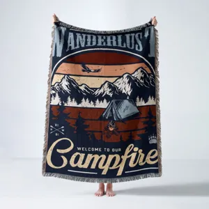 Detailed macro view of bohemian woven camping blanket with mountain and tent design