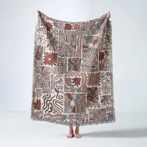 Detailed macro view of bohemian woven throw blanket with fringe and sunburst motifs