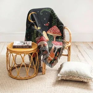 Detail view showing the mushroom and nature pattern on a Bohemian woven tassel blanket
