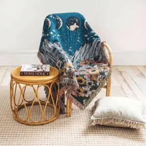 Detailed woven bohemian throw blanket with floral and mountain landscape on a chair