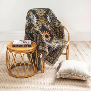 Macro detail of bohemian woven throw blanket with celestial sun and moon fringe patterns