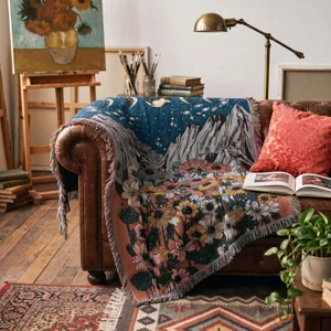 Detailed view of bohemian woven throw blanket with sunflower and mountain landscape design.