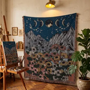 Bohemian woven tapestry blanket with moon and floral design in art studio