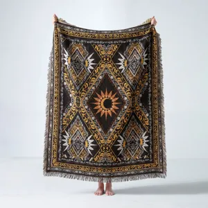 Detail of bohemian woven outdoor picnic blanket with intricate sun moon pattern