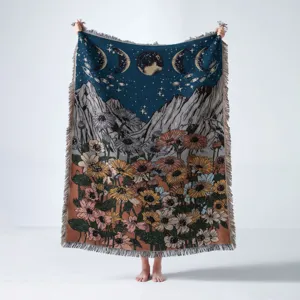 Bohemian woven landscape blanket featuring moon phases and floral mountain design