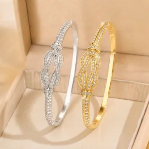 Detailed view of dual-color pave crystal knot bangles showcasing fine sparkle and elegance.