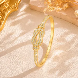 Detailed shot of exquisite gold infinity knot pavé rhinestone bracelet, luxury jewelry design.