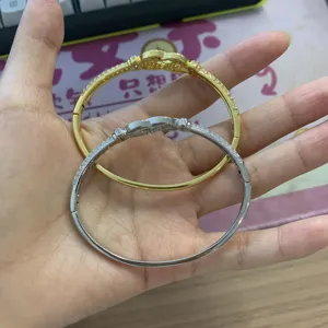 Elegant infinity knot pavé crystal hinged bangles in stunning gold and silver colors.