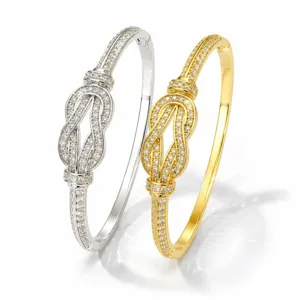 Close-up of double-tone paved knot bracelet detail, sparkling rhinestone fine design.