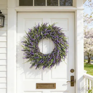 Realistic artificial lavender wreath hanging on a white front door for spring decor