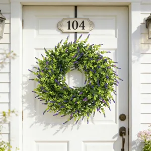 Artificial lavender and boxwood wreath hanging on a white front door as decor