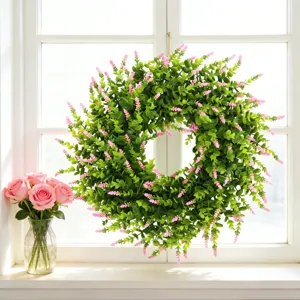 Vibrant artificial lavender and boxwood wreath displayed on a white window sill