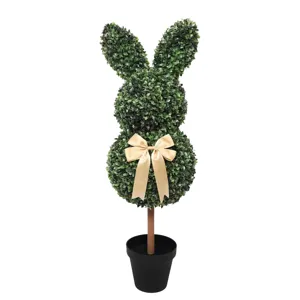 Faux boxwood rabbit topiary in a black pot with a gold bow for Easter garden decor